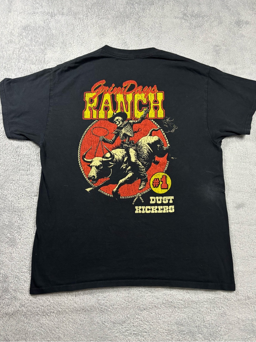 Grim Days black t-shirt with red and yellow accents.